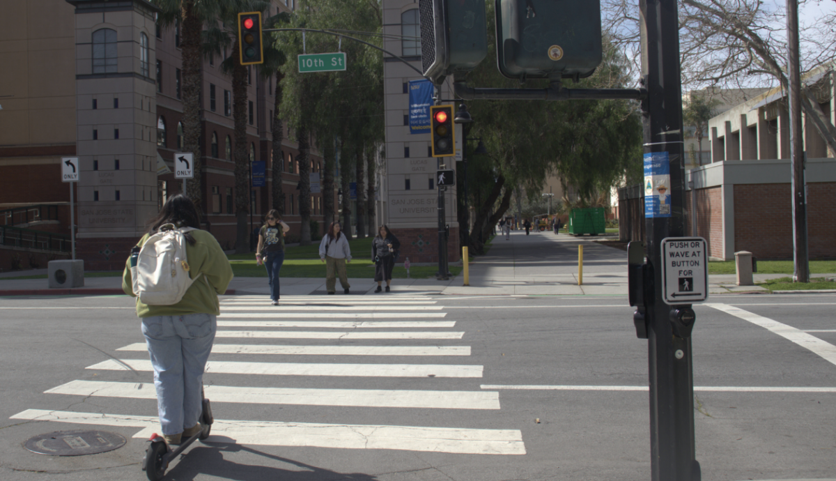 SJSU students cross 10th Street near the east campus entrance on Monday during Commuter Appreciation Week.